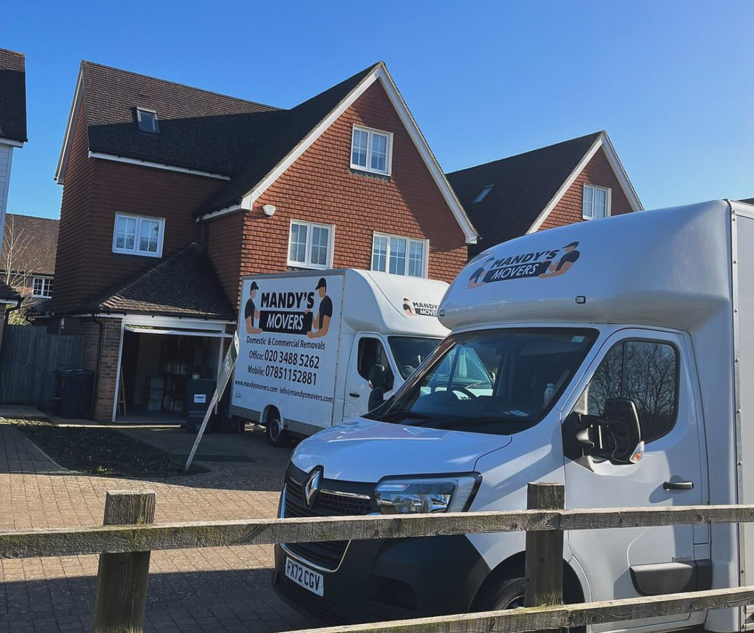 2 mandys movers vans outside house for house move